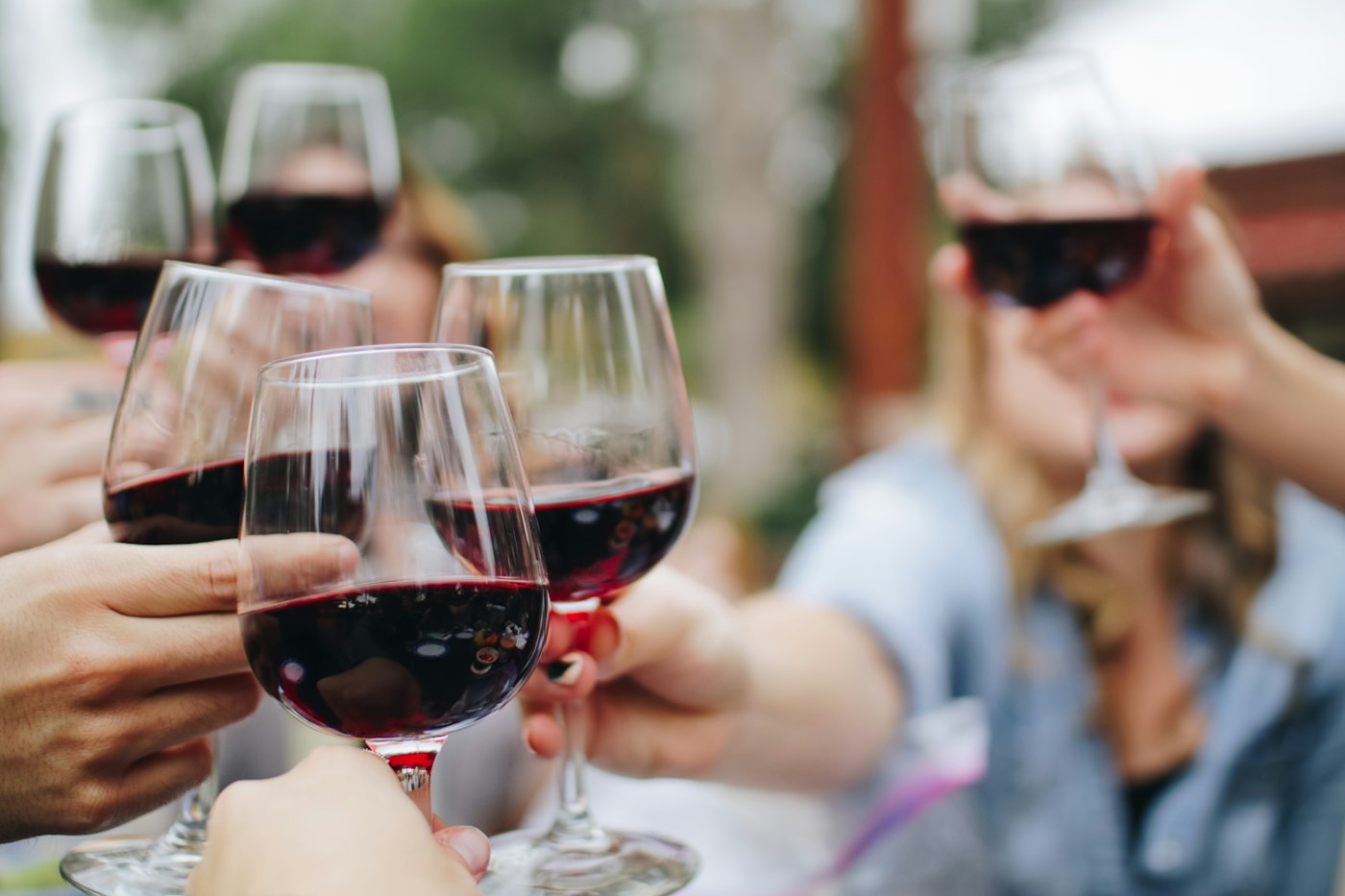 Wine glasses raised in a tasting
